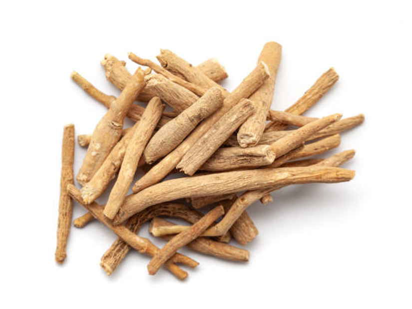 A pile of dried ashwagandha roots on a white background