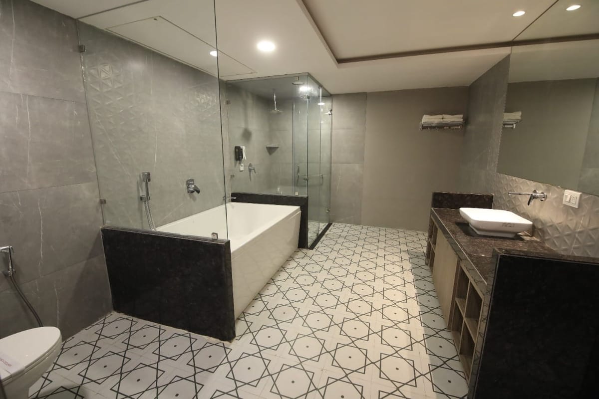Suite bathroom with bathtub and shower at Crestline Shubh Vilas, Jaipur