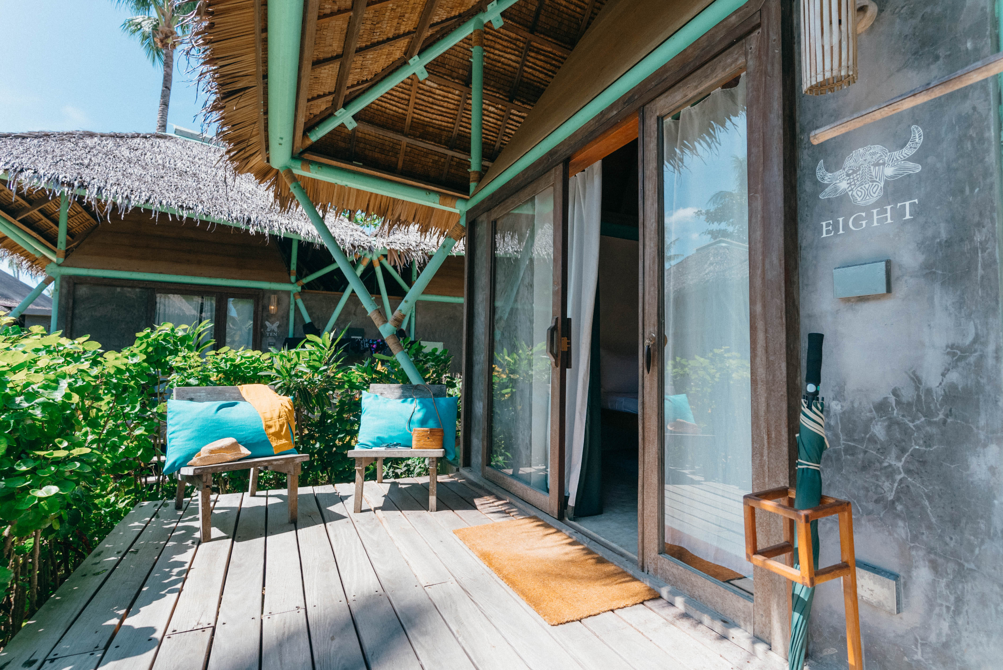 The thatched-roof deck entrance of the Double Room at Bravo Beach Resort Siargao with a numbered room sign