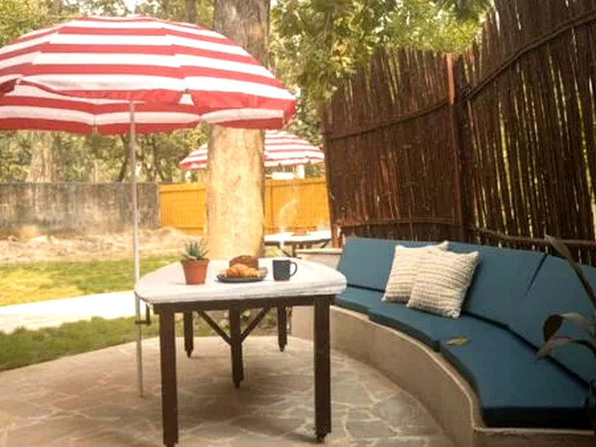 An open-air table set on the lawns at Signum Resort, Bandhavgarh