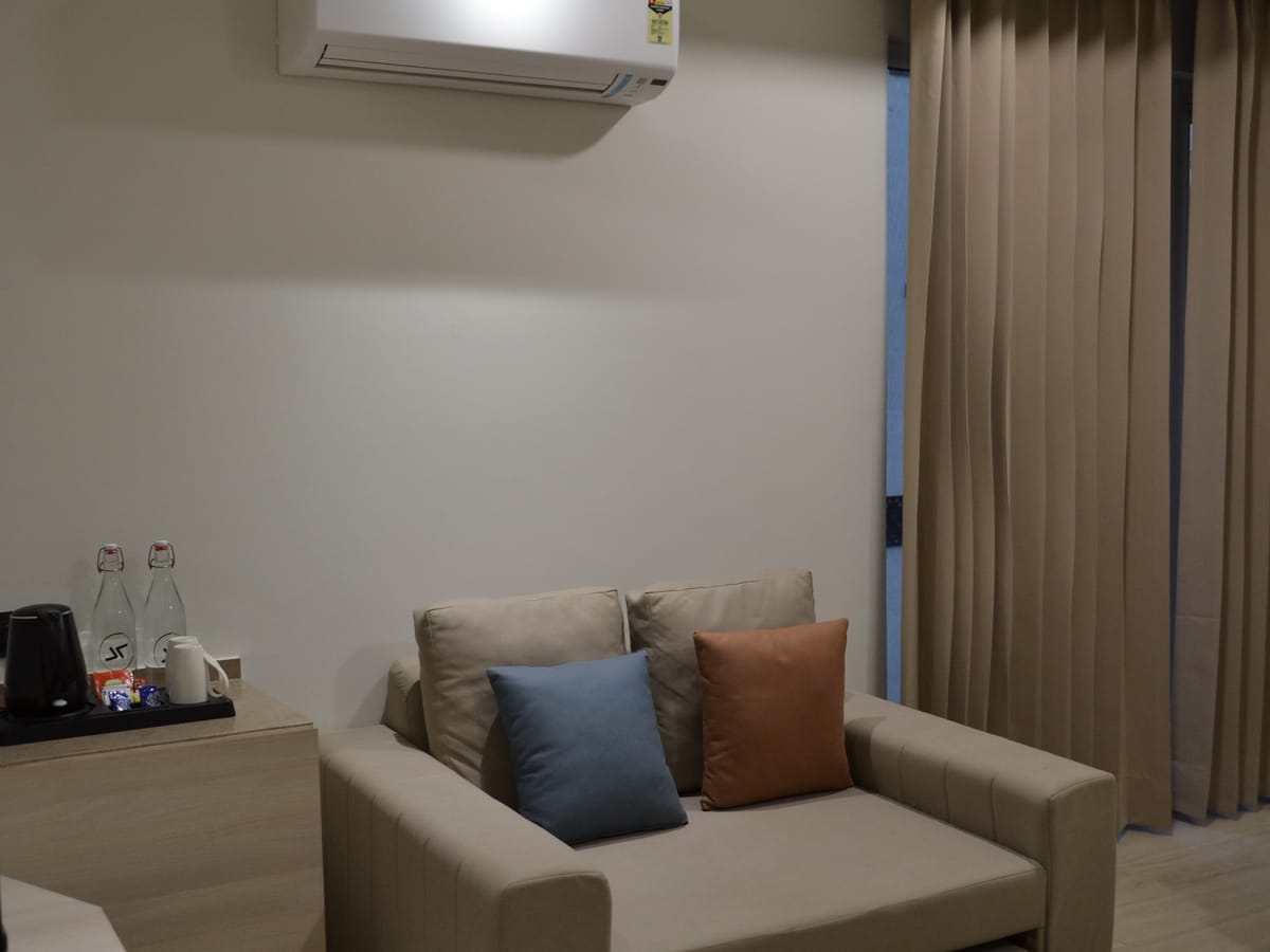 Seating beside the window in a Deluxe Double Room at Signum Tathastu Boutique Hotel, Haridwar