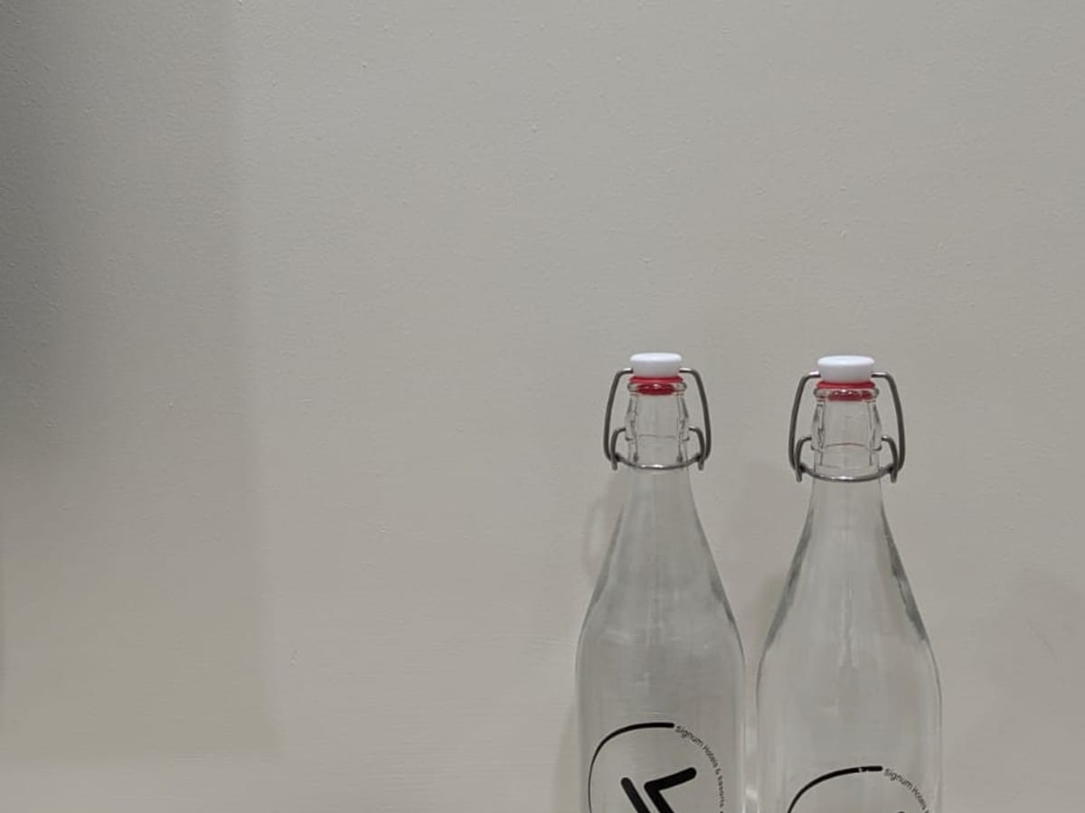 Glass water bottles provided for guests at Signum Tathastu Boutique Hotel, Haridwar