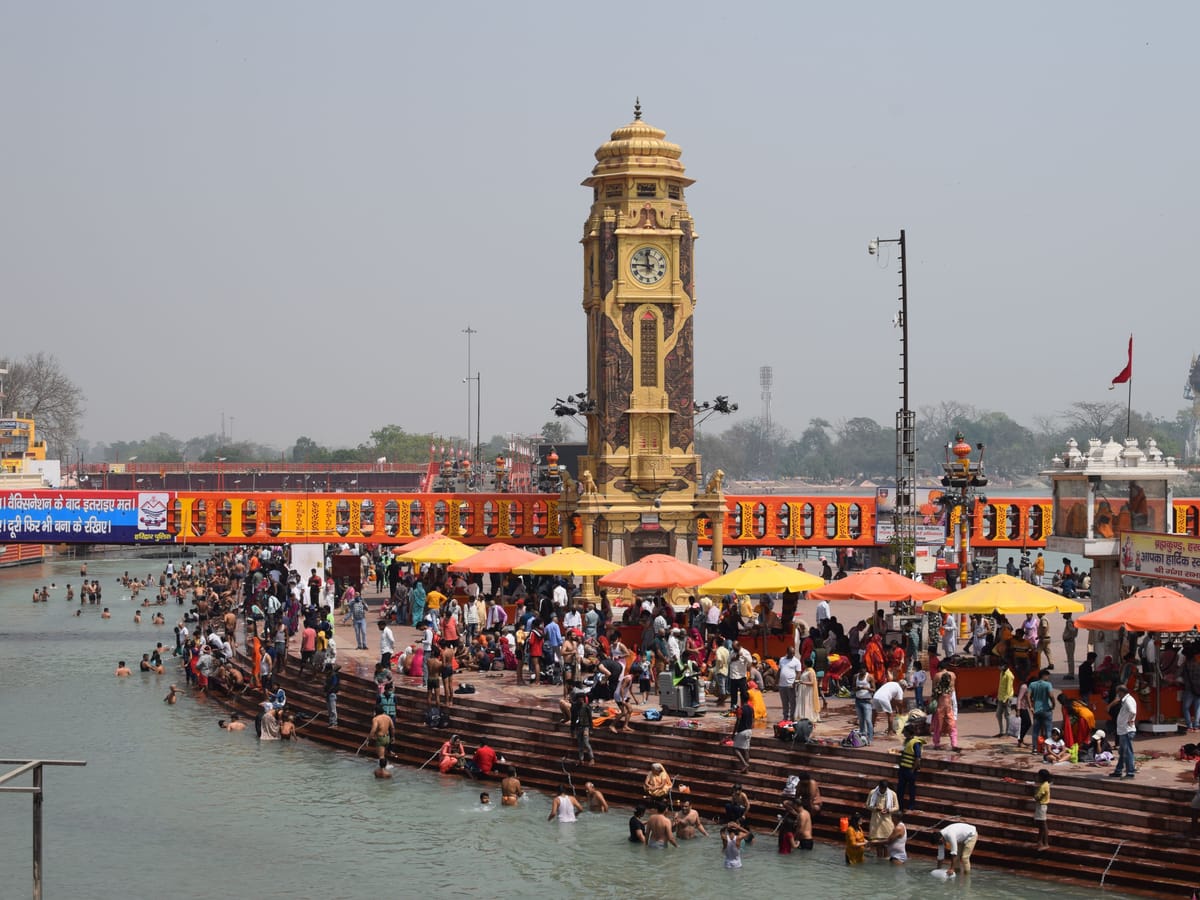 Pilgrims on the steps at Har Ki Pauri, Haridwar, below the clock tower