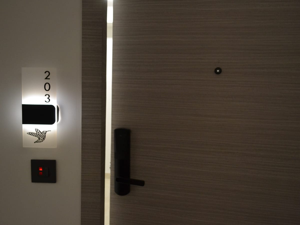 A guest room entrance along the corridor at Signum Tathastu Boutique Hotel, Haridwar