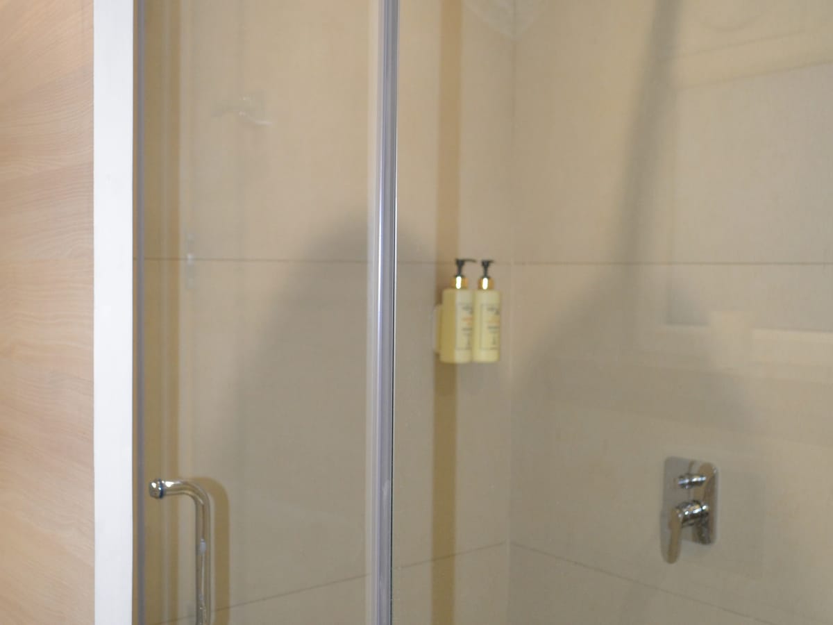 The glass shower partition in a bathroom at Signum Tathastu Boutique Hotel, Haridwar