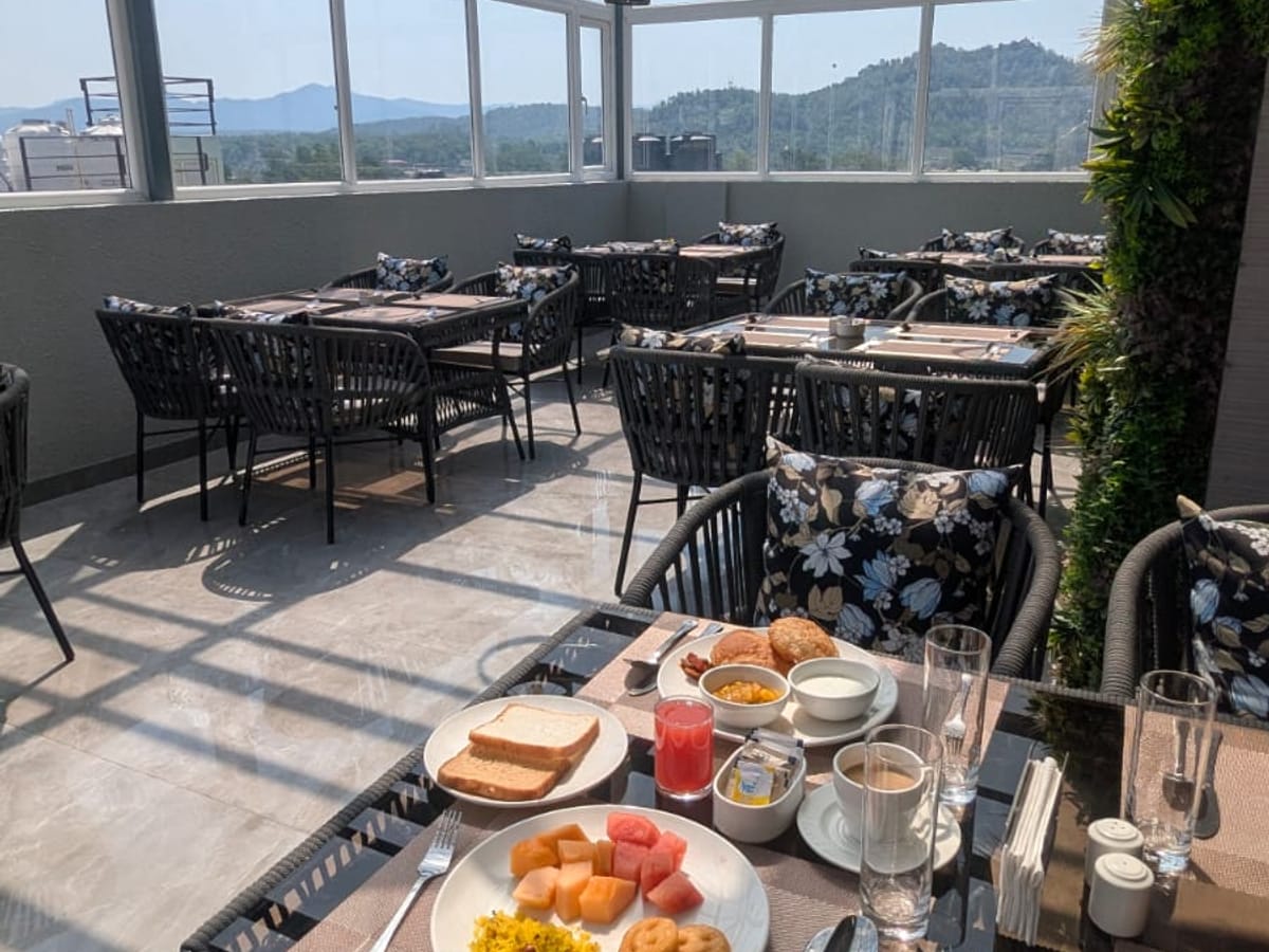 A breakfast spread on the rooftop terrace at Signum Tathastu Boutique Hotel, Haridwar