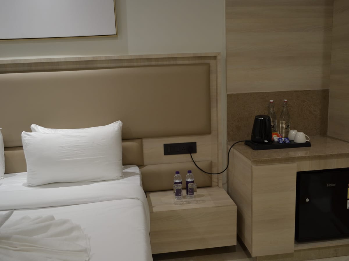 The bed in a Standard Double Room at Signum Tathastu Boutique Hotel, Haridwar