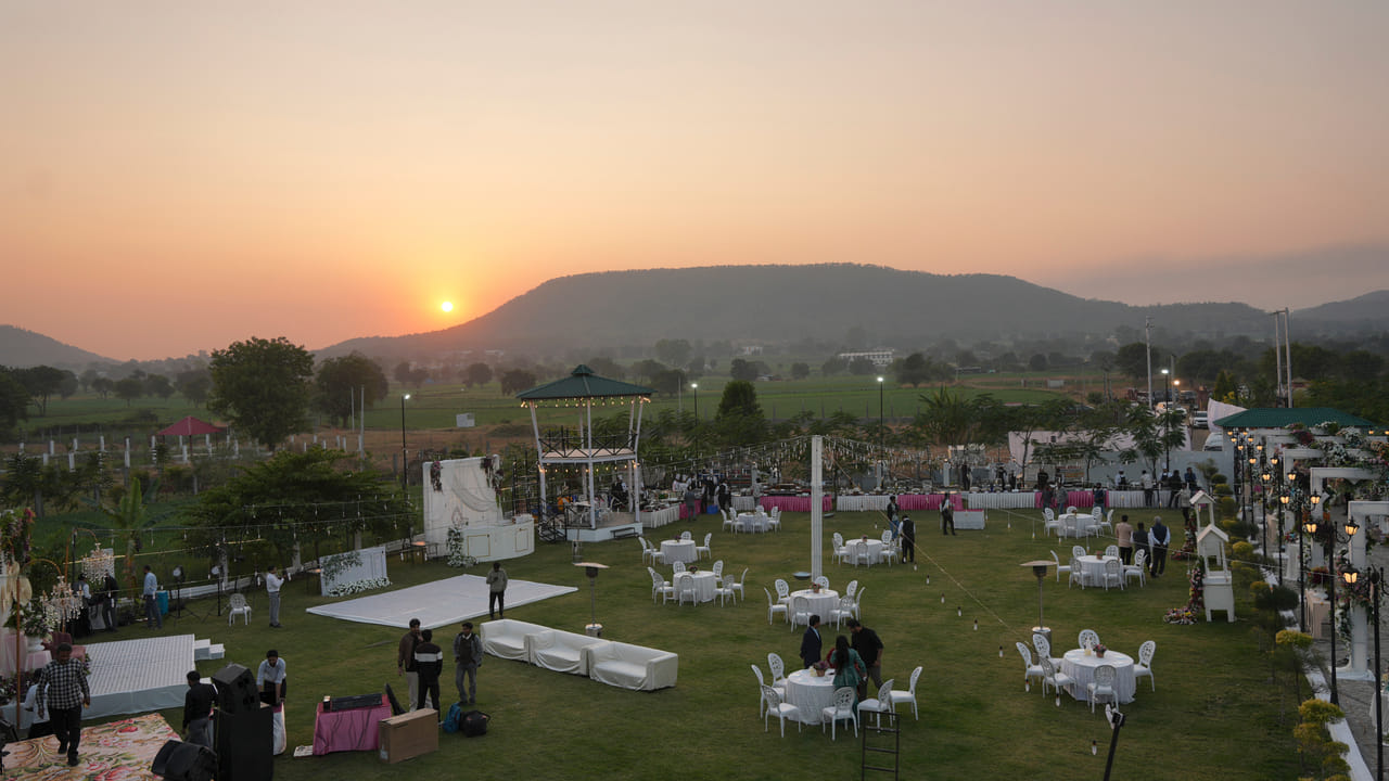 A wedding lawn set for a celebration at sunset