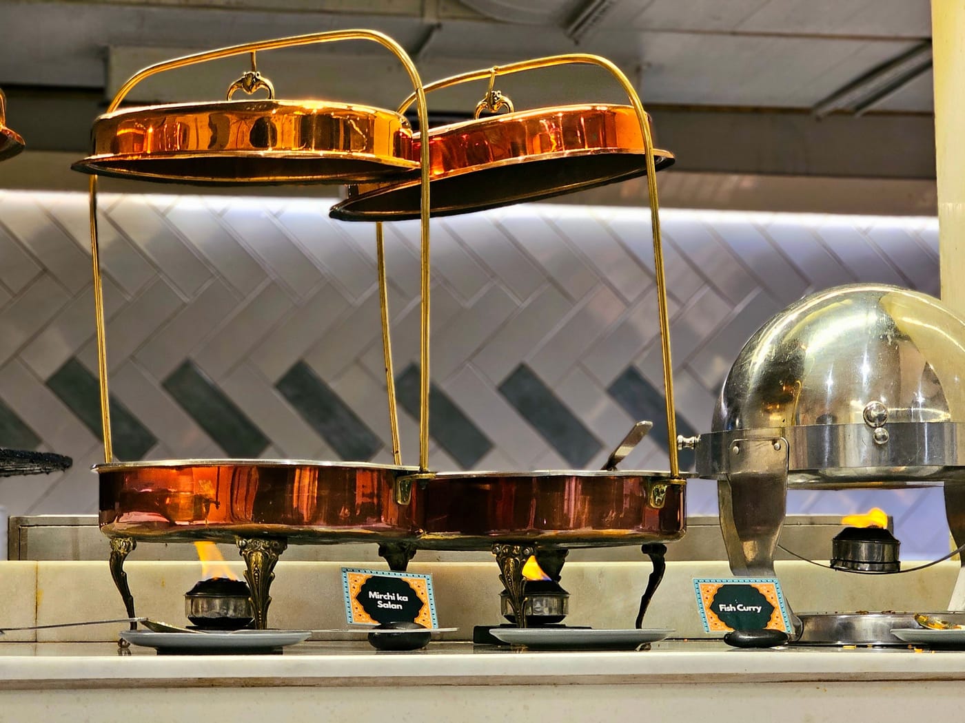 Chafing dishes on the buffet counter at Signum CityScapes SKY Boutique Hotel, Indore