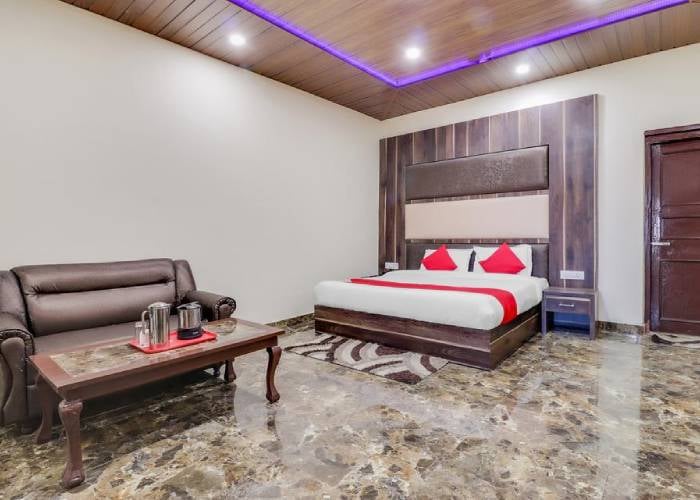 Deluxe Room at Hotel Himdhara with a tea tray on the table beside the sofa
