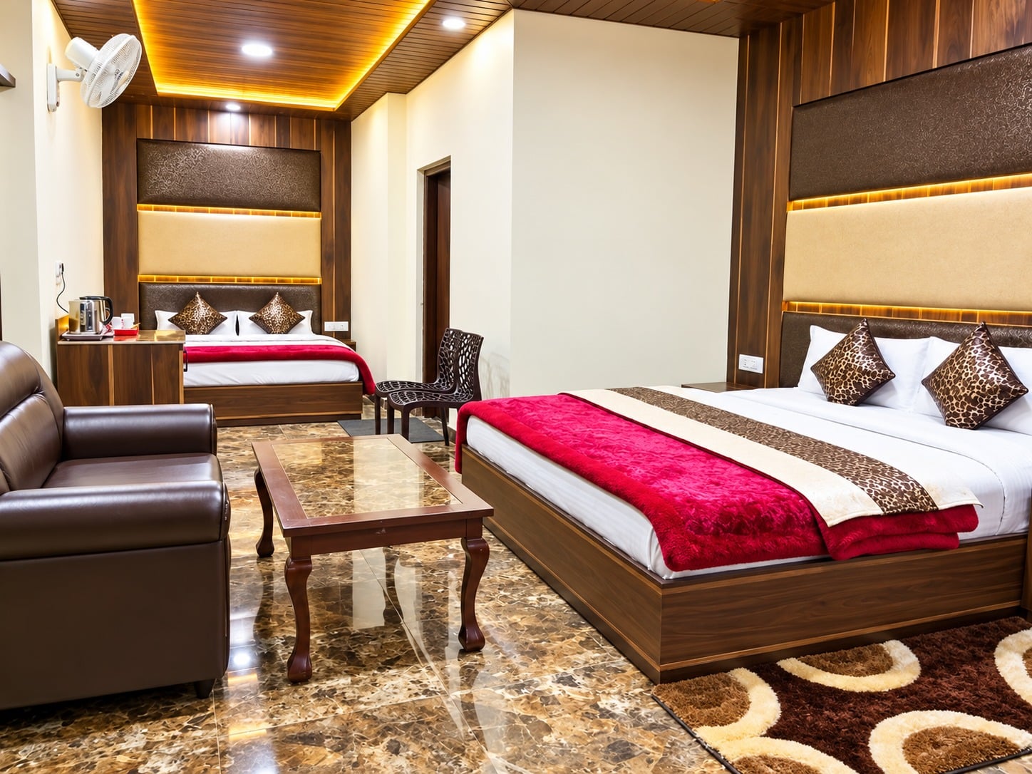 Family Suite at Hotel Himdhara with two double beds, a sofa, and a centre table