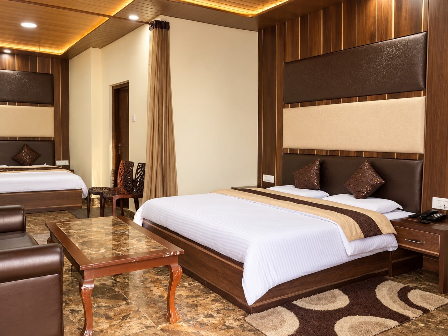 Family Suite at Hotel Himdhara with two beds side by side under a wooden ceiling