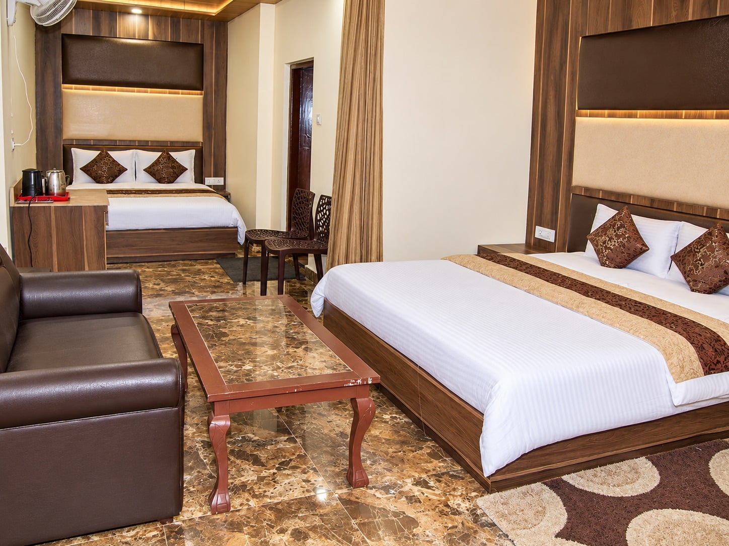 Family Suite at Hotel Himdhara with two beds, a seating area, and a tea and coffee tray