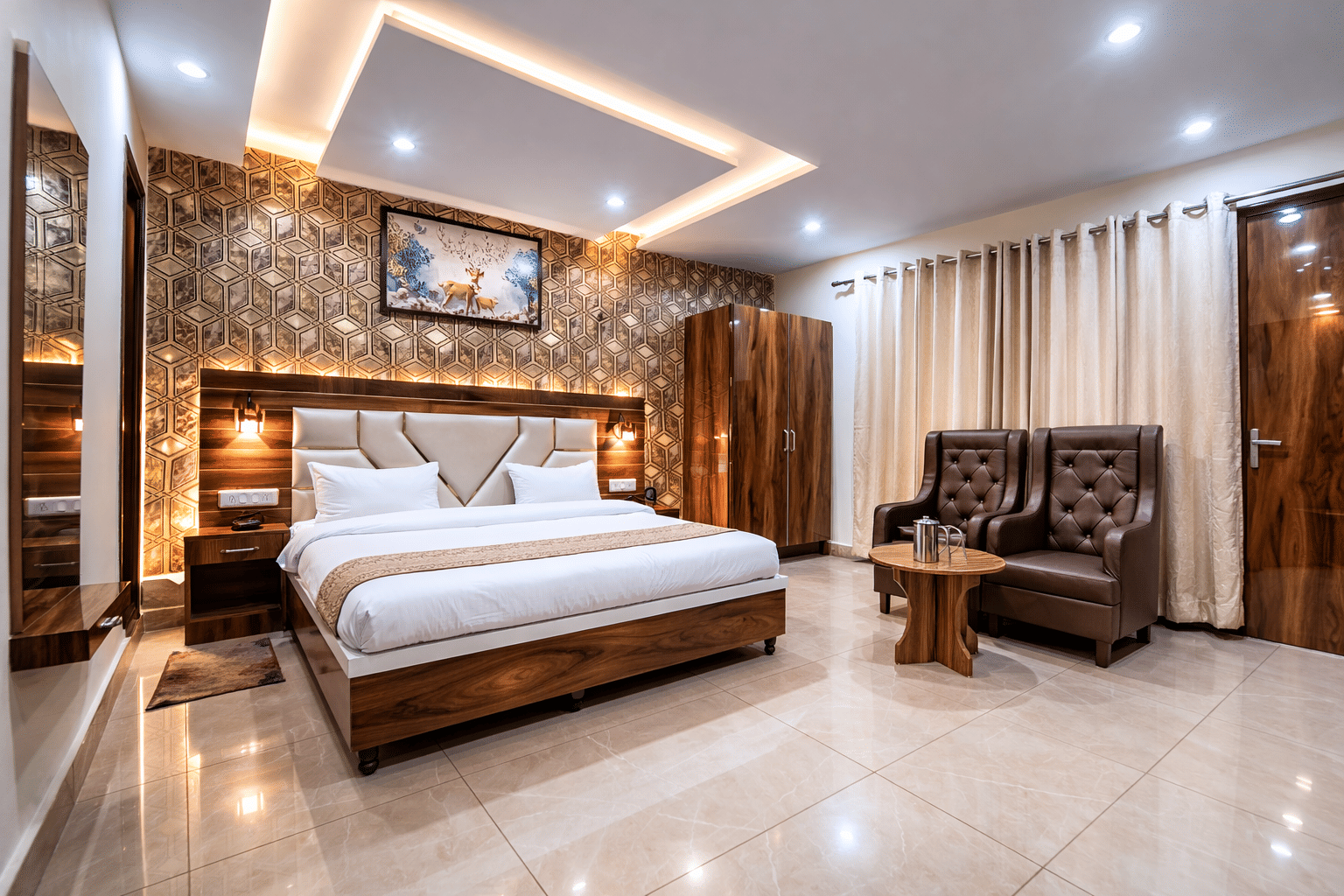 A guest room with armchairs at JPT Hotels, Dalhousie