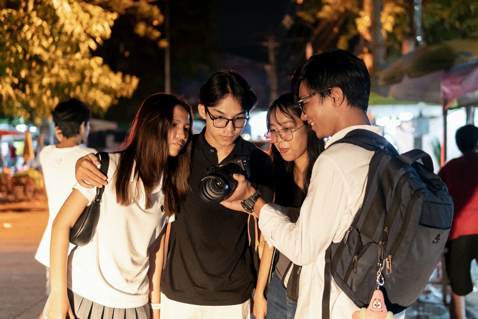 Young travellers looking at photos on a camera