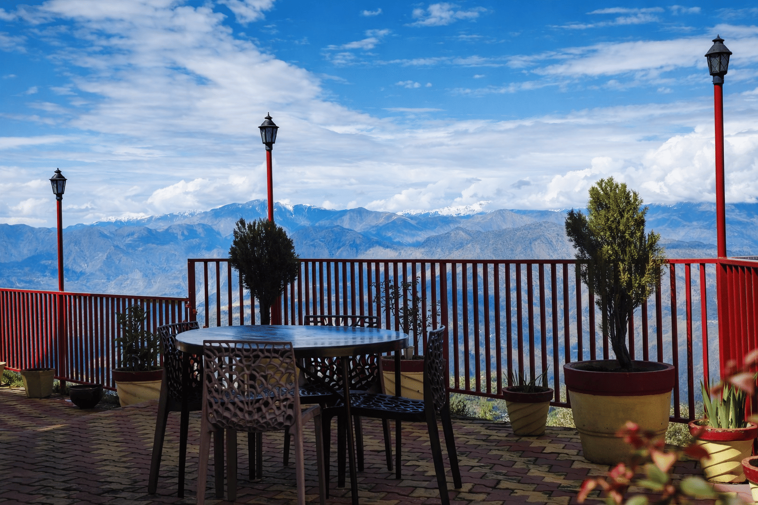 An outdoor terrace table with a view over the hills