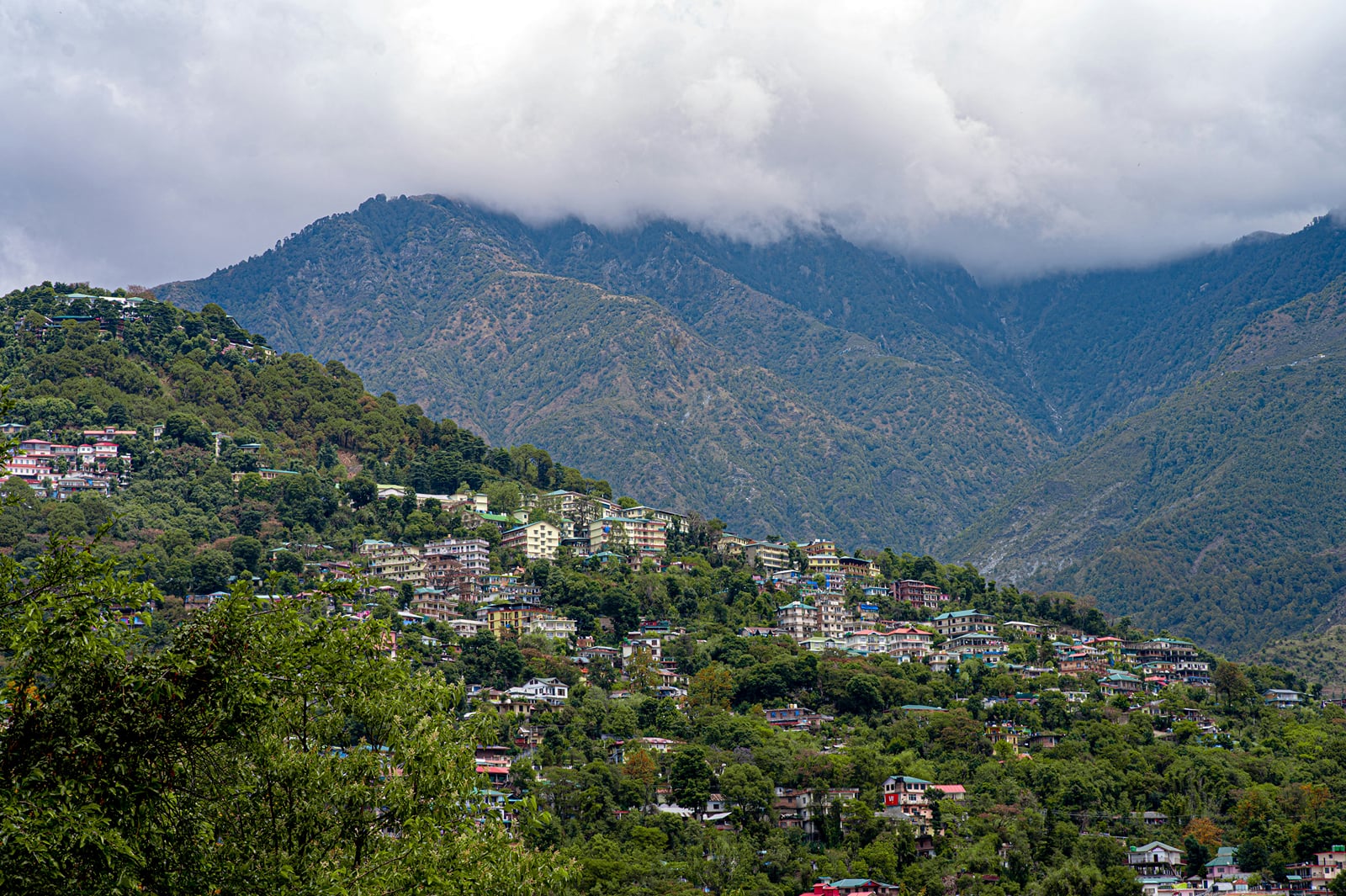 Dharamshala on its hillside under the clouds