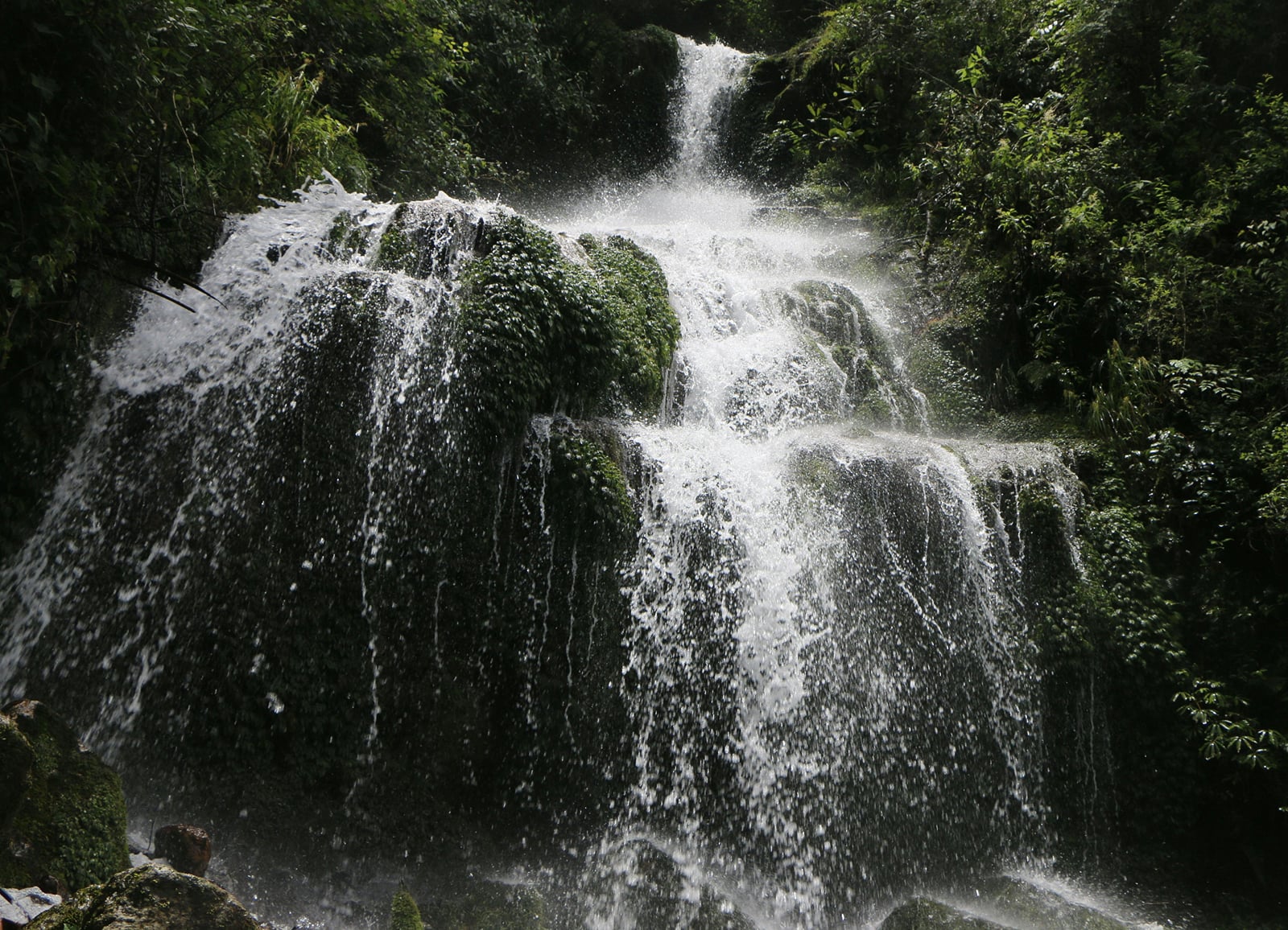 Satdhara Falls spilling over mossy rocks near Dalhousie