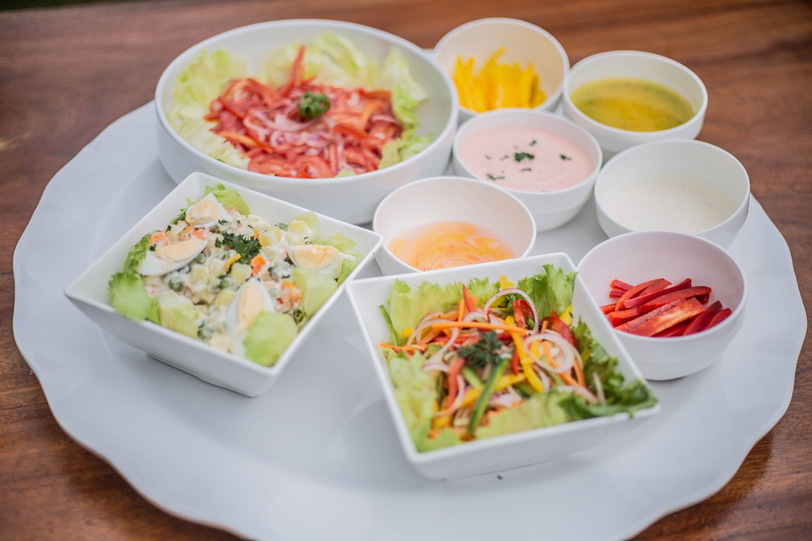 Fresh salads and dressings served on a platter