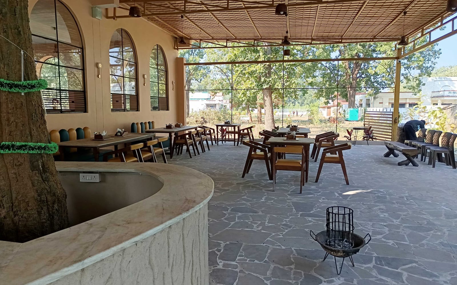 Outdoor restaurant seating at Signum Resort, Bandhavgarh