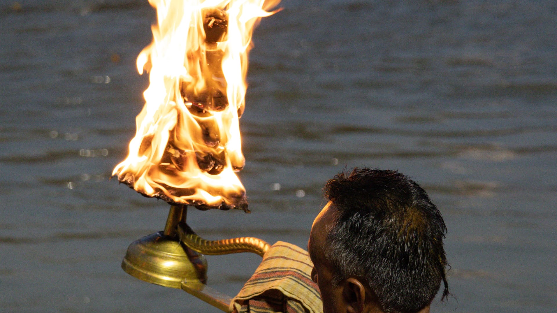 A priest performing the evening Ganga Aarti on the ghats at Haridwar