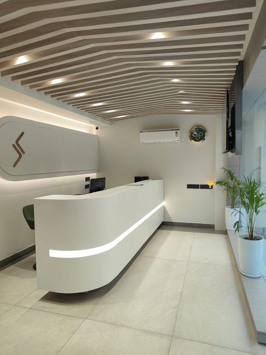 The reception desk at Signum Tathastu Boutique Hotel, Haridwar, below a backlit Signum monogram