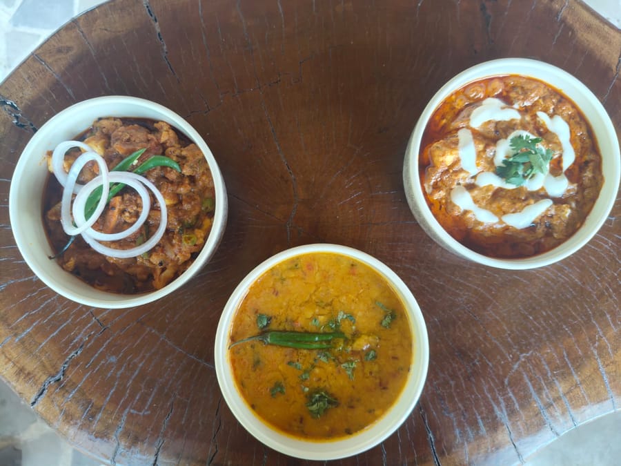 Bowls of food cooked over the clay chulha at Signum Resort, Bandhavgarh