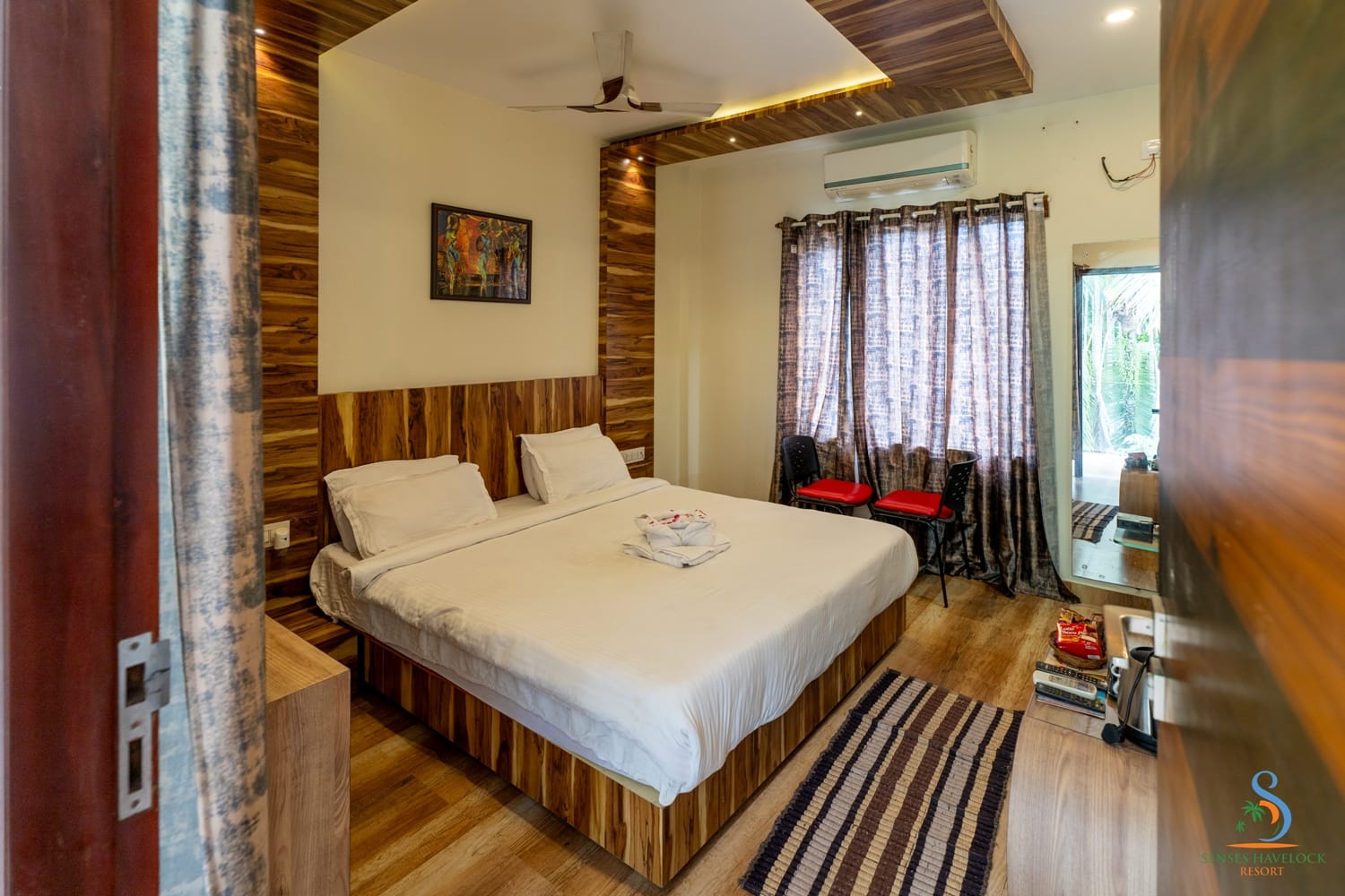 The bed and timber headboard wall in a Deluxe Room
