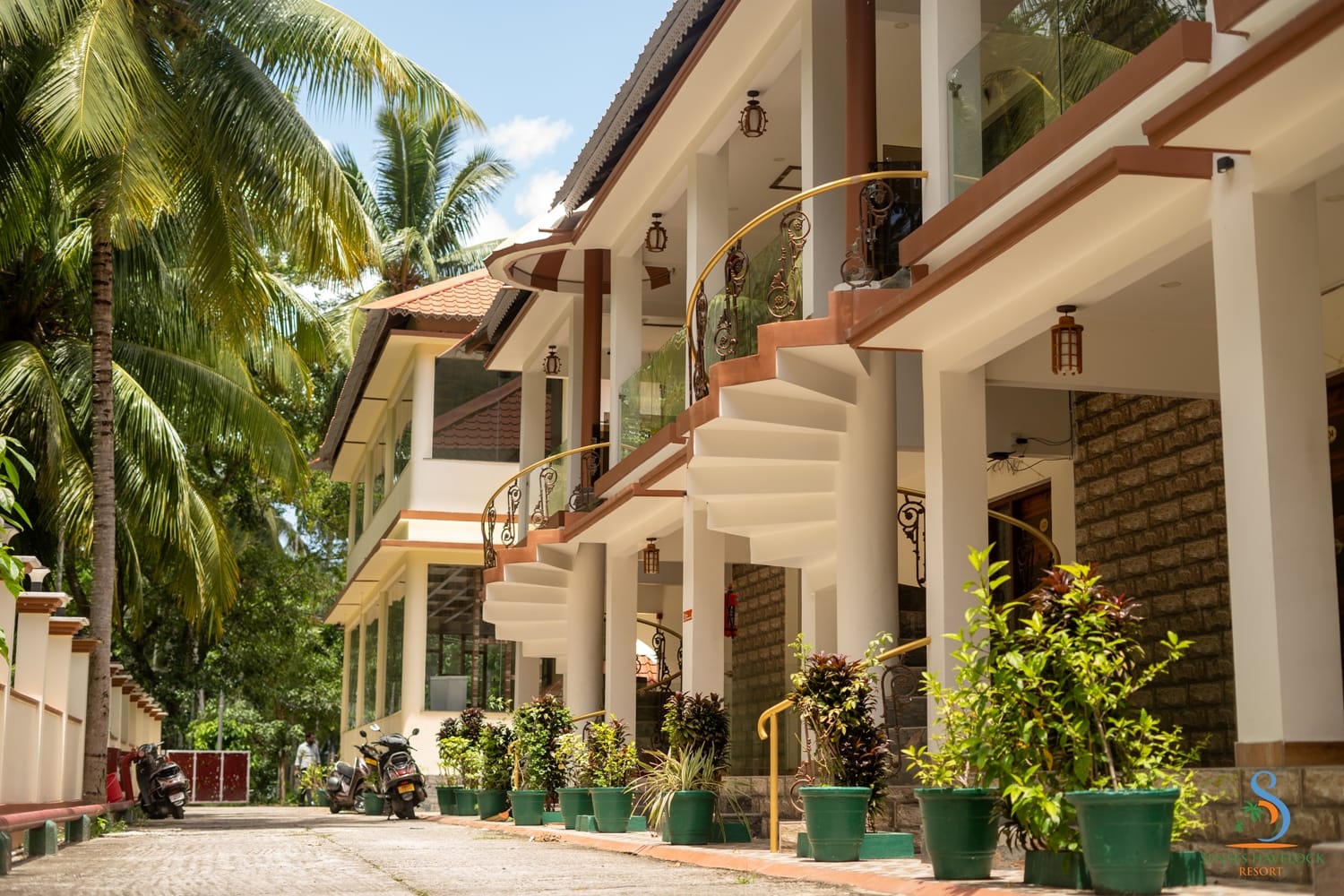 Terracotta-roofed room blocks set among palms at Senses Havelock Resort