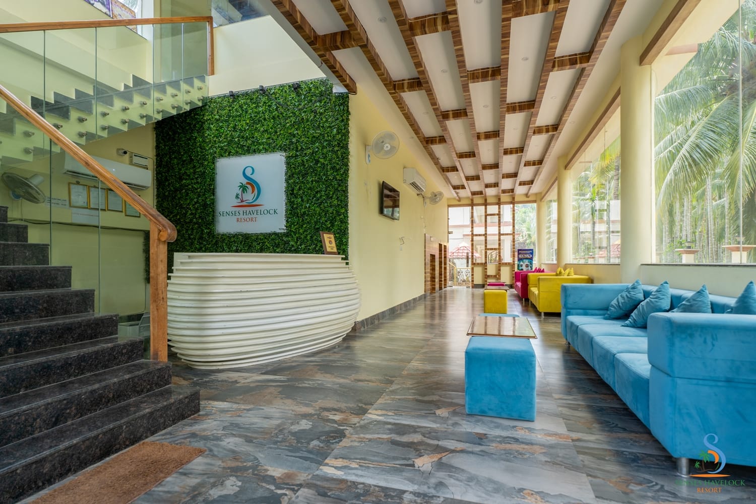 The lobby looking down its length, the curved reception desk on the left and lounge seating along the windows