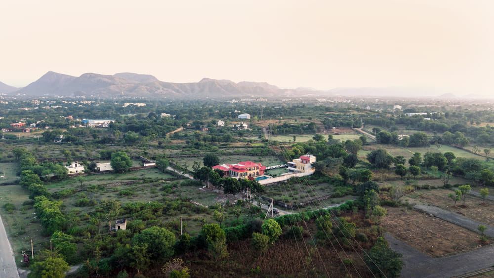 Nazaara Hills Retreat surrounded by green landscape and the Aravalli hills of Udaipur