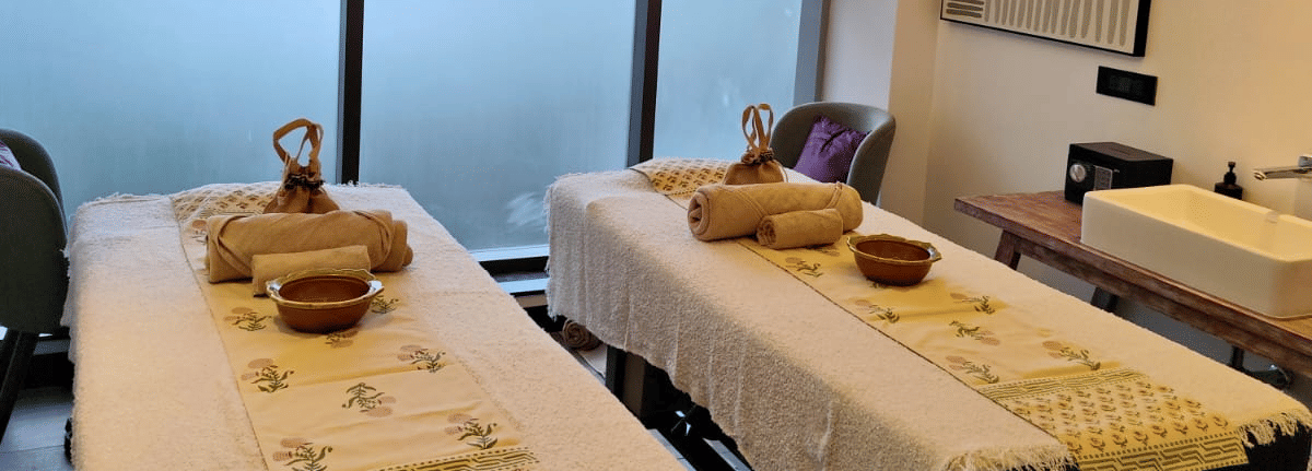 Tattva at Sands Point spa treatment room featuring twin massage beds and a tranquil setting