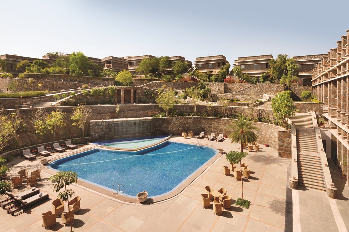 The courtyard pool with sun loungers at Ramada by Wyndham Udaipur Resort and Spa