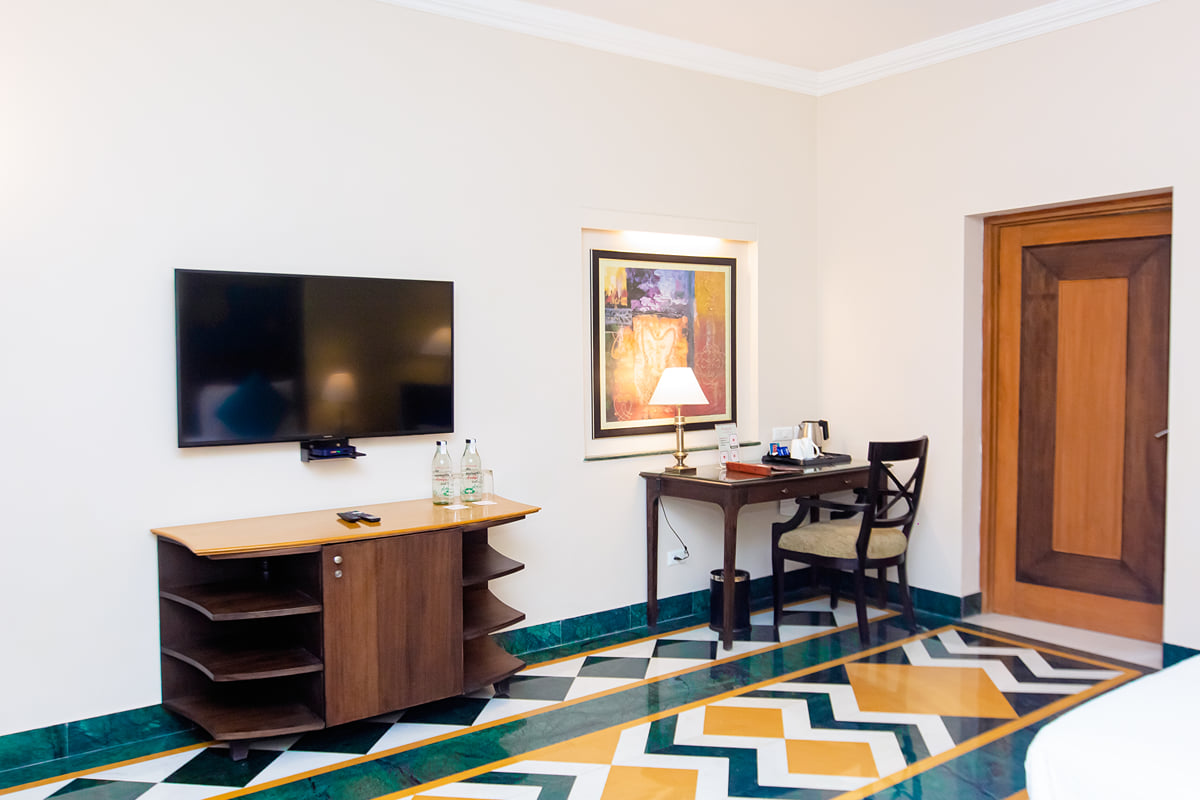 Deluxe Room work desk and TV at Ramada by Wyndham Udaipur Resort and Spa