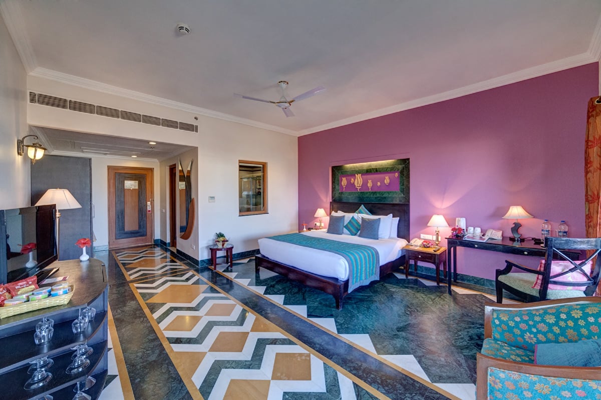 Deluxe Room with a double bed and seating at Ramada by Wyndham Udaipur Resort and Spa