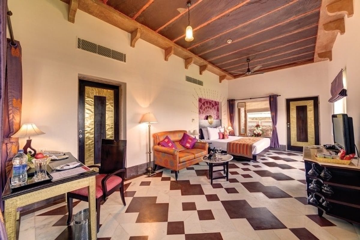 Premium Room with a sofa and desk at Ramada by Wyndham Udaipur Resort and Spa