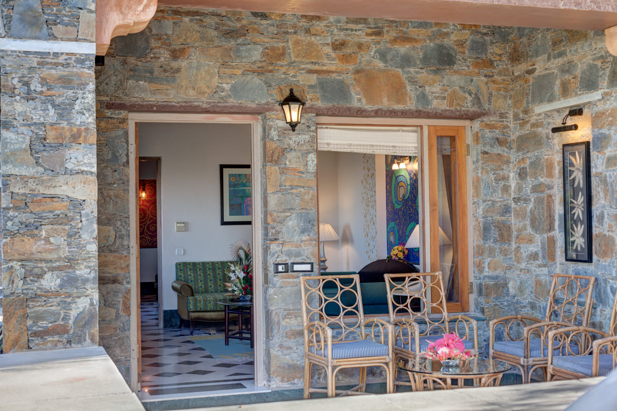 Suite private sit-out with wicker chairs at Ramada by Wyndham Udaipur Resort and Spa