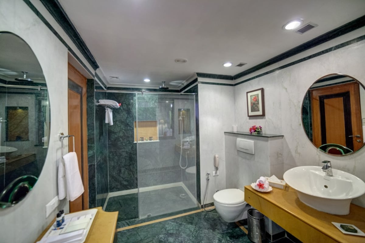 Super Deluxe Room bathroom at Ramada by Wyndham Udaipur Resort and Spa
