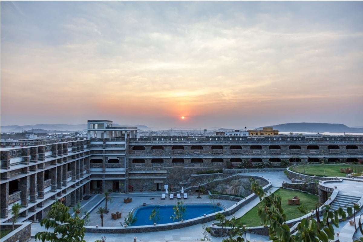 Aerial view of the pool and rooms at sunset at Ramada by Wyndham Udaipur Resort and Spa