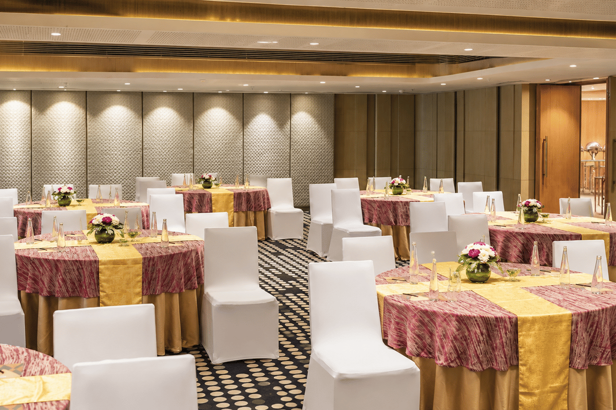 Allure I & II banquet hall with round tables on a chequered carpet