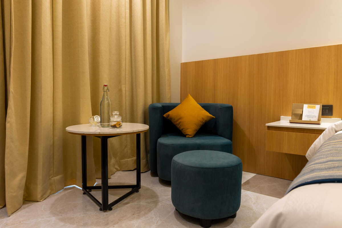 King bed and work desk in an Executive King room at Triumph Regency OMR Chennai