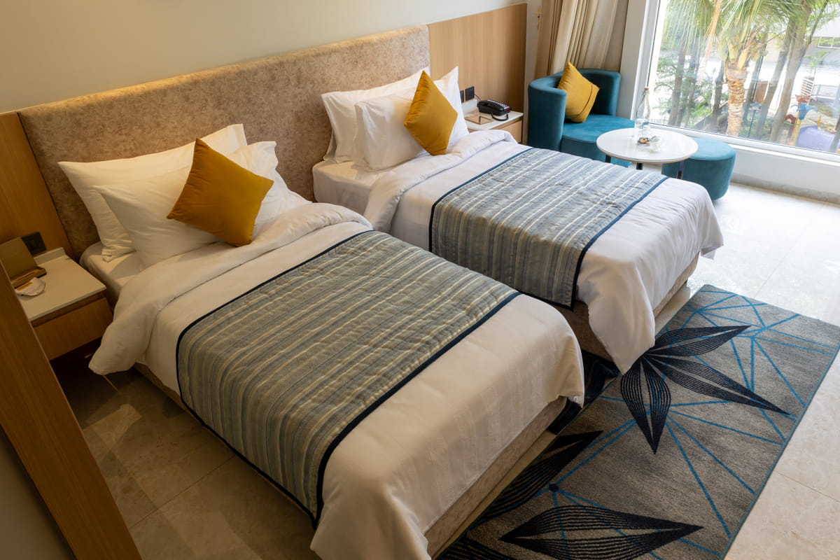 Executive Twin room with twin beds and a garden view at Triumph Regency OMR Chennai