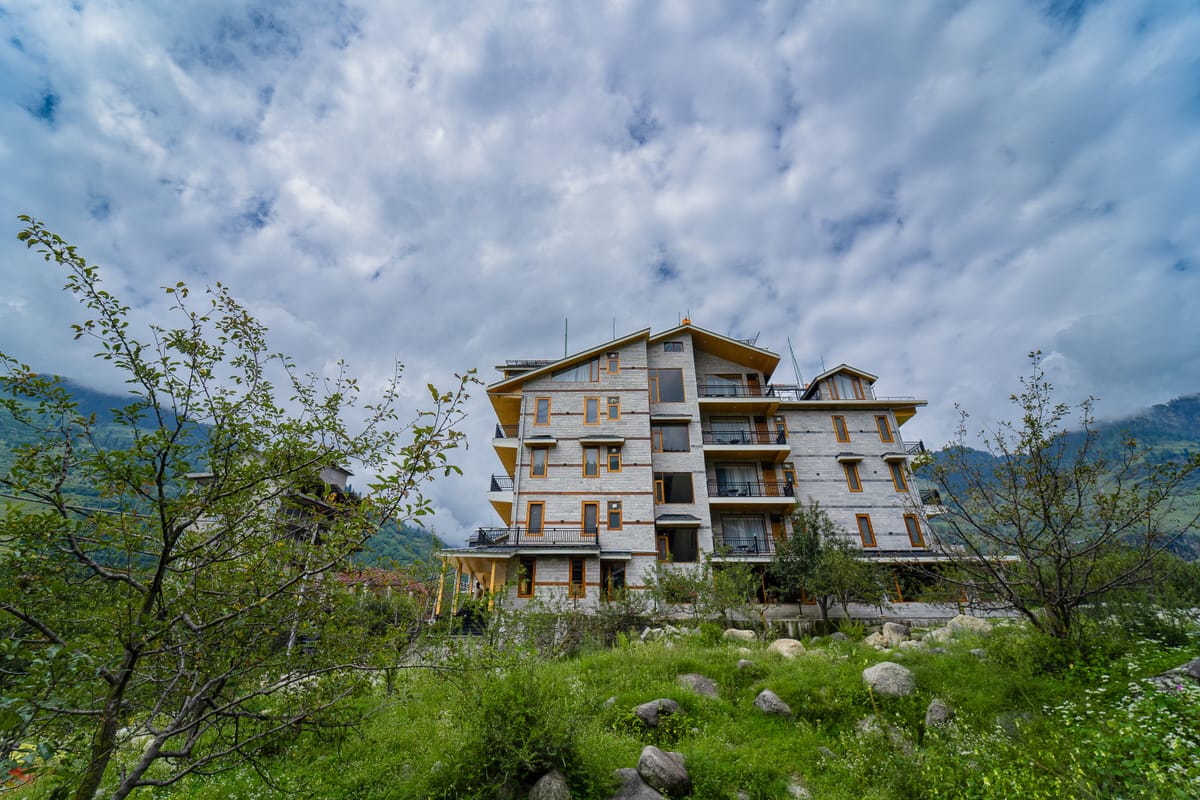 Nazaara Luxe Retreat, Manali, seen from the orchard below the hillside