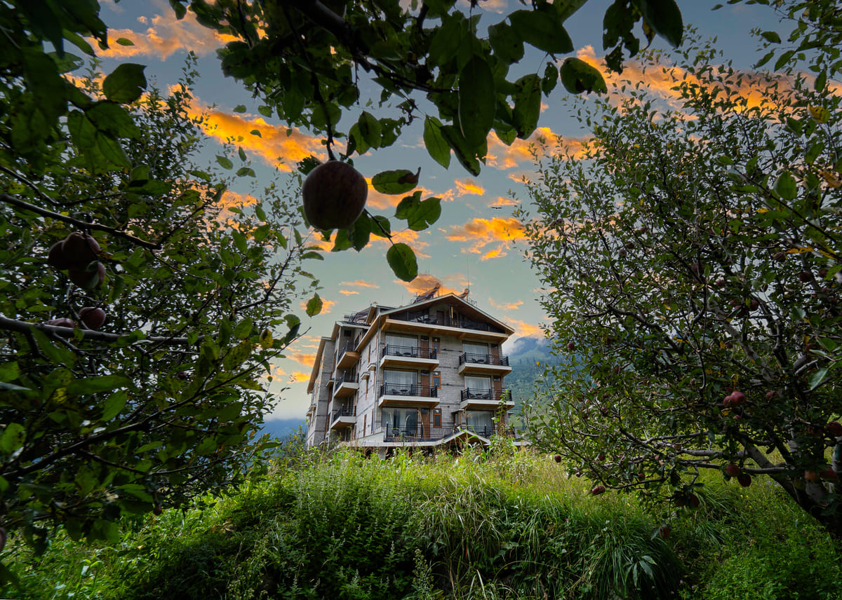 Nazaara Luxe Retreat, Manali, facade at sunset above the orchard