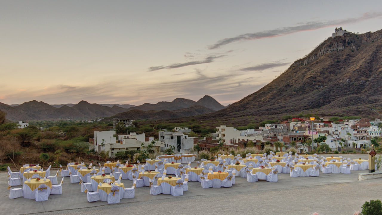 Open-air terrace set for an evening event at Ramada by Wyndham Udaipur Resort and Spa