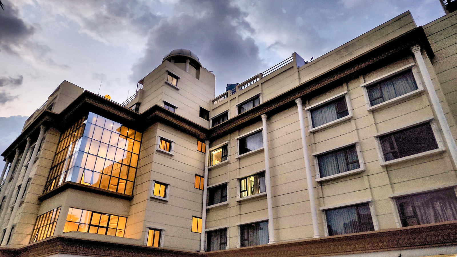 Hotel City Heart, Shirdi, facade at dusk with lights on