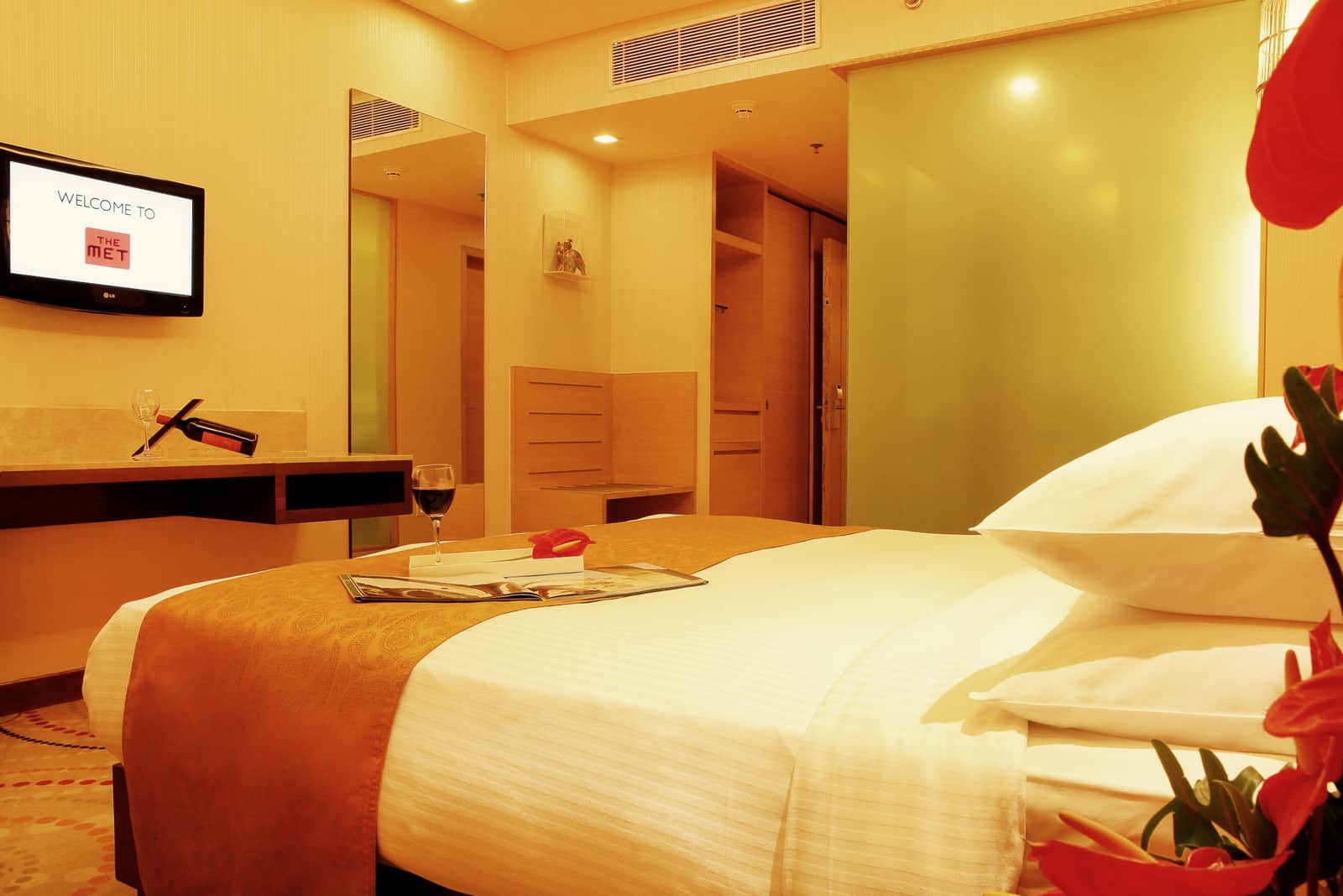 The bed and side table in a Deluxe Room