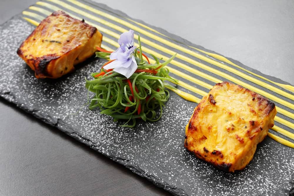 A tandoor dish plated on slate at Chutney