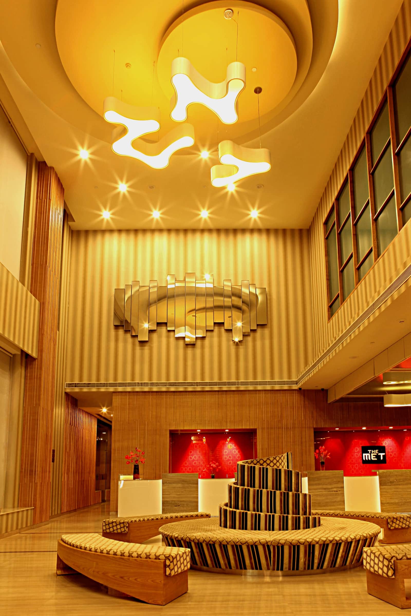 The lobby, its lights above and the glass on the wall