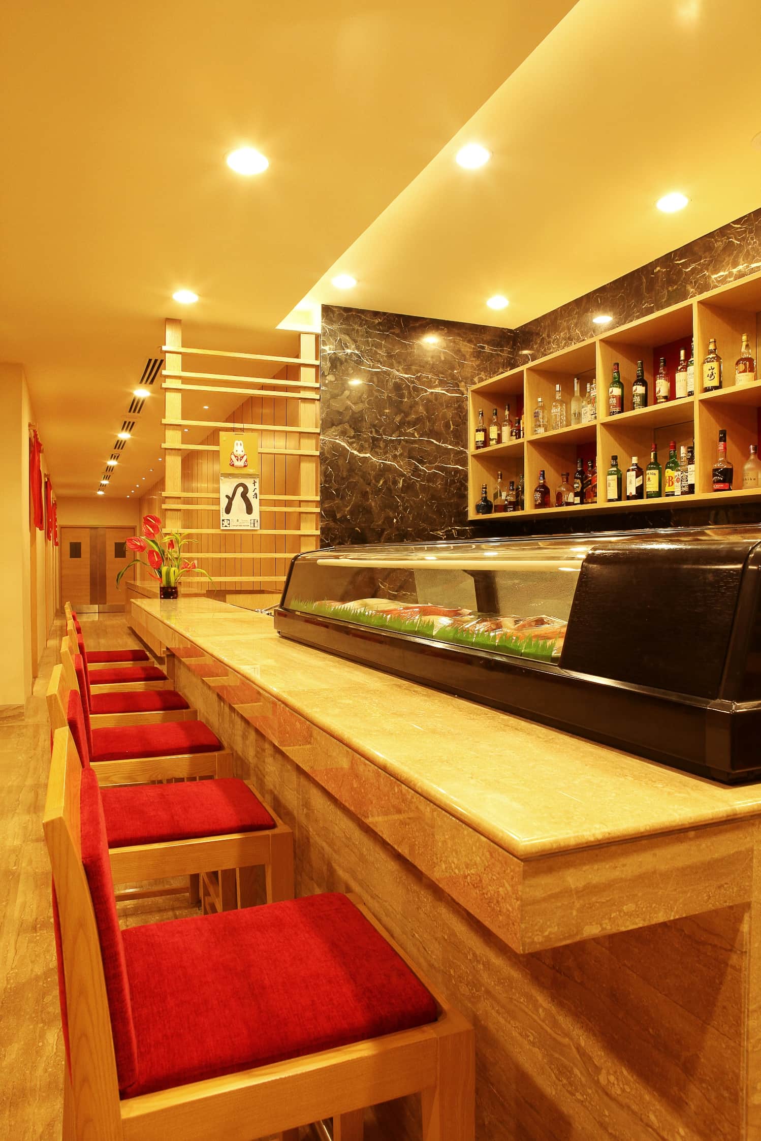 The sushi counter at Sakura with its red stools